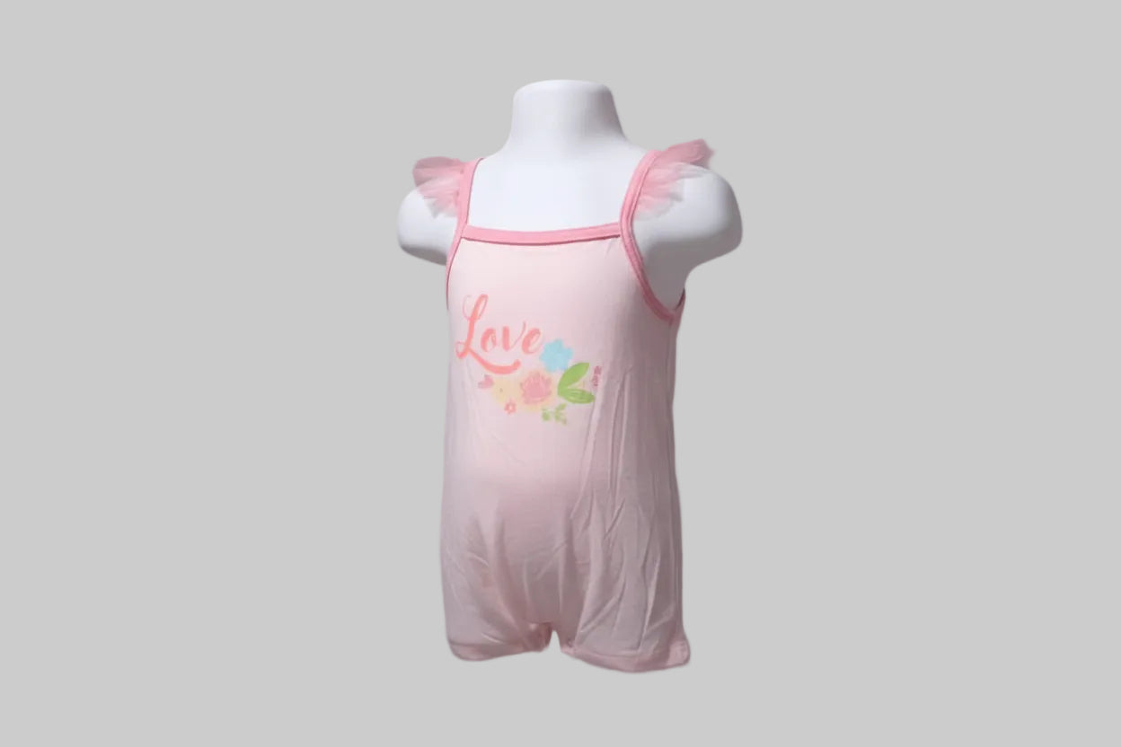 Pink baby romper with floral design and 'Love' text on a mannequin in a store setting.