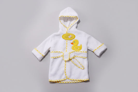 White baby robe with yellow accents and a duck design on a green textured background